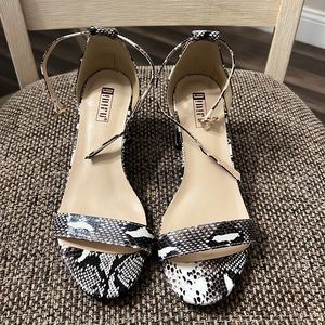 Size 6.5, 1.5 inch snakeskin heels with adjustable straps.